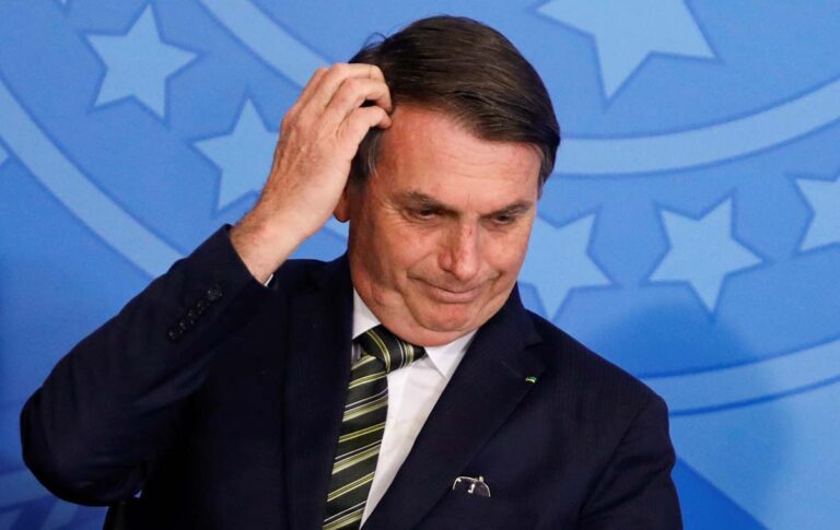 Brazil's President Jair Bolsonaro gestures during a review and modernization ceremony of occupational health and safety work at the Planalto Palace in Brasilia